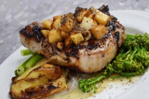 grilled steak with vegetables on white ceramic plate